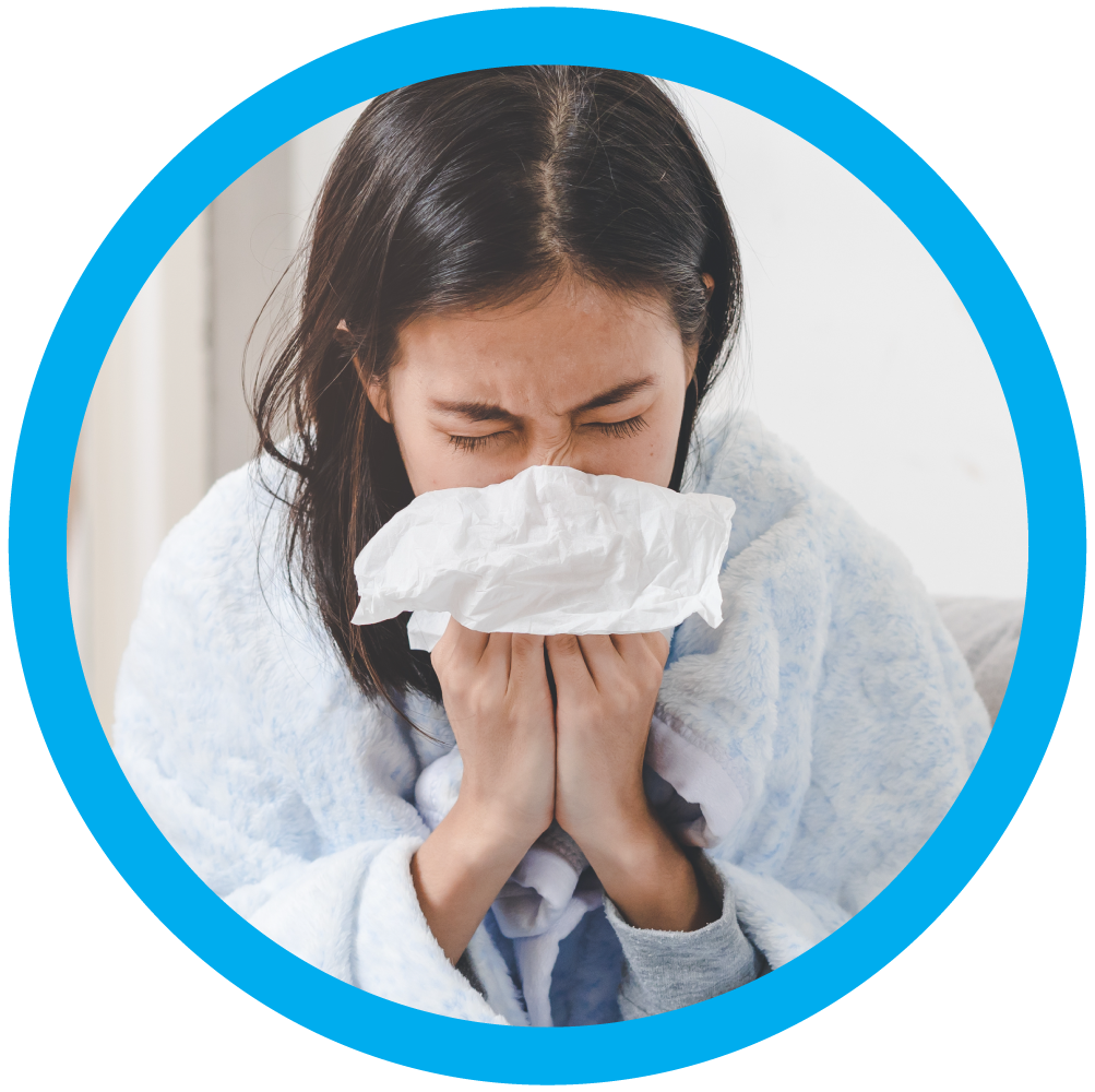 A sick woman blows her nose.